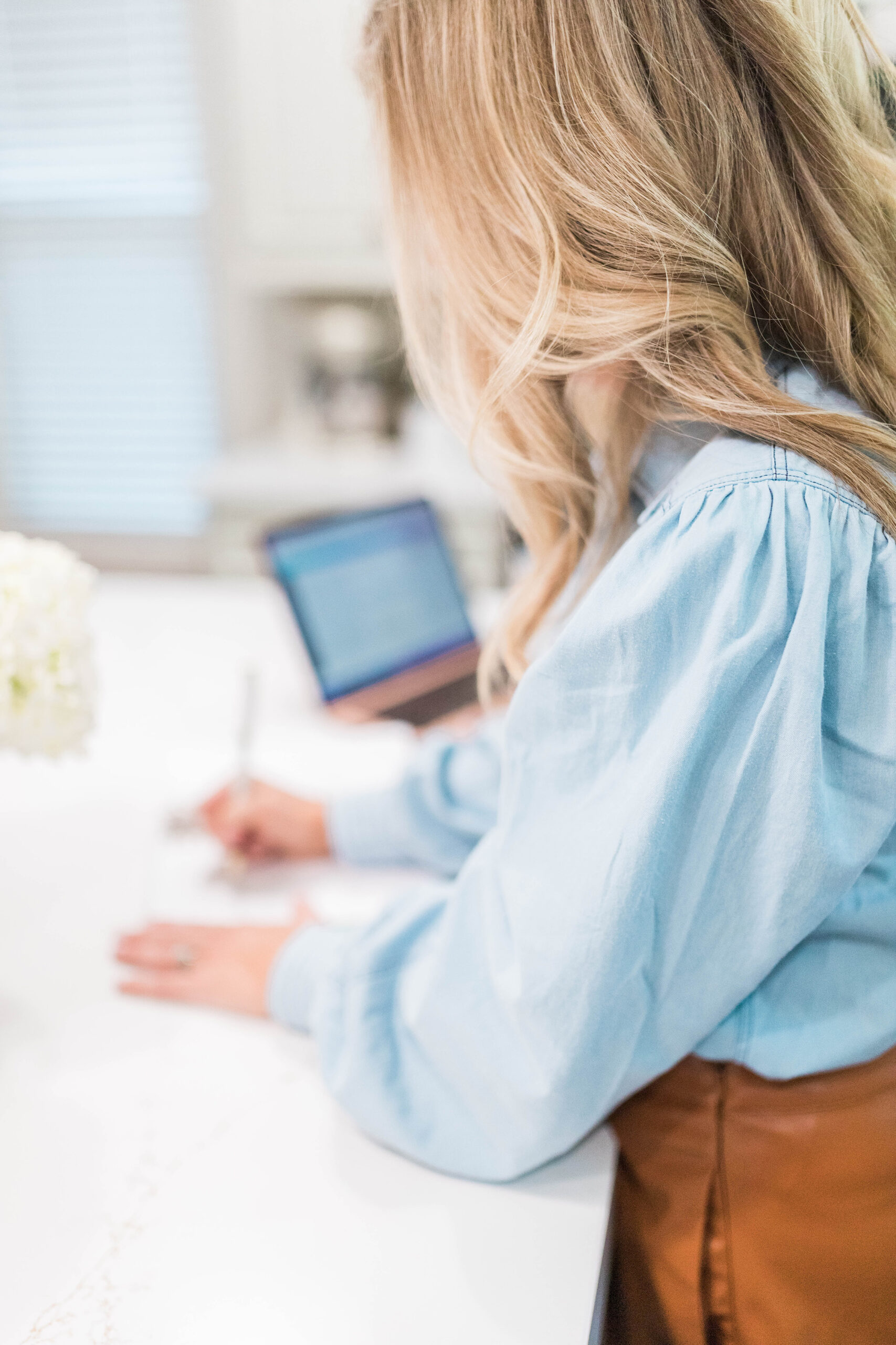 woman writing at desk, increase google rankings