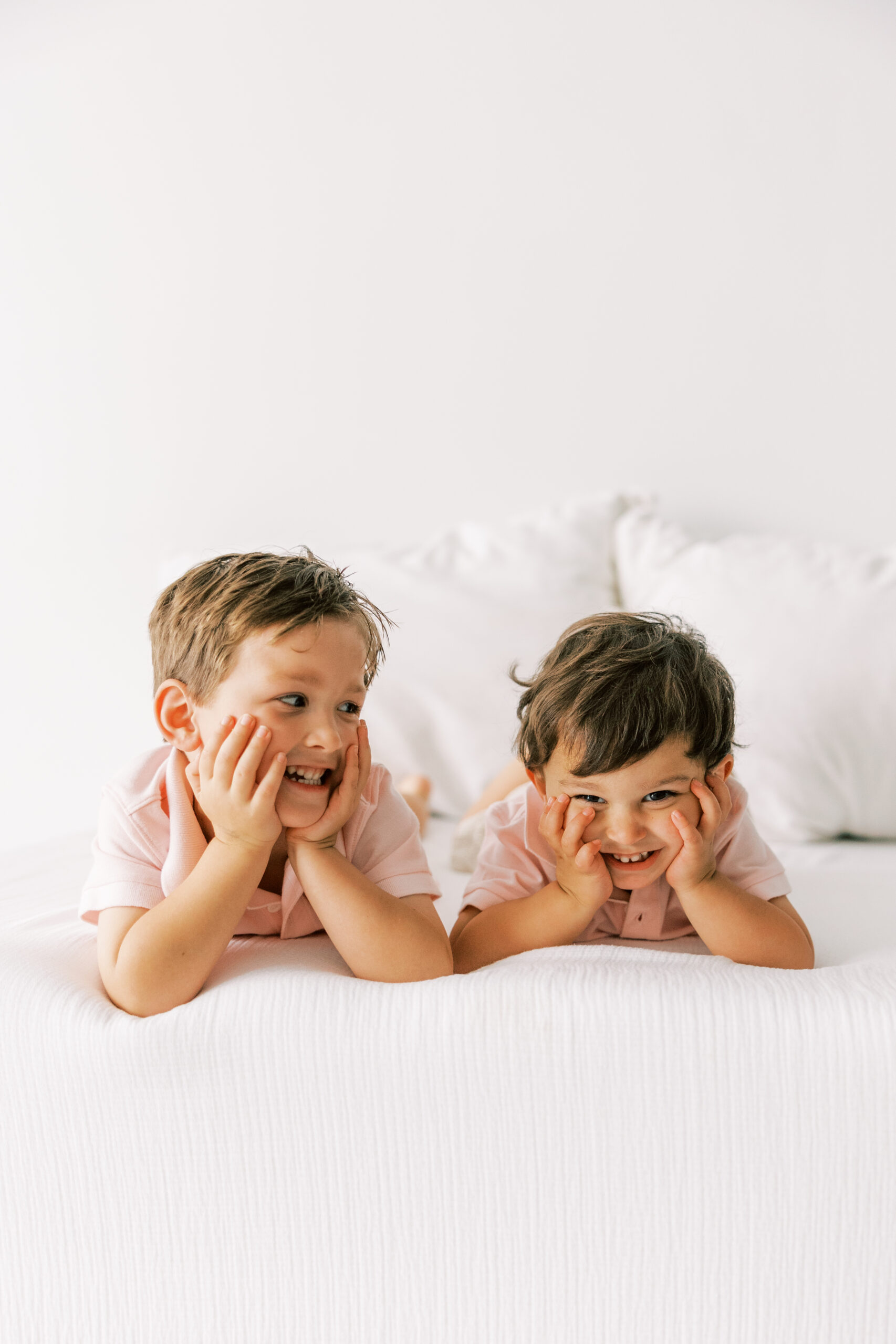 boys laying on the bed making silly faces