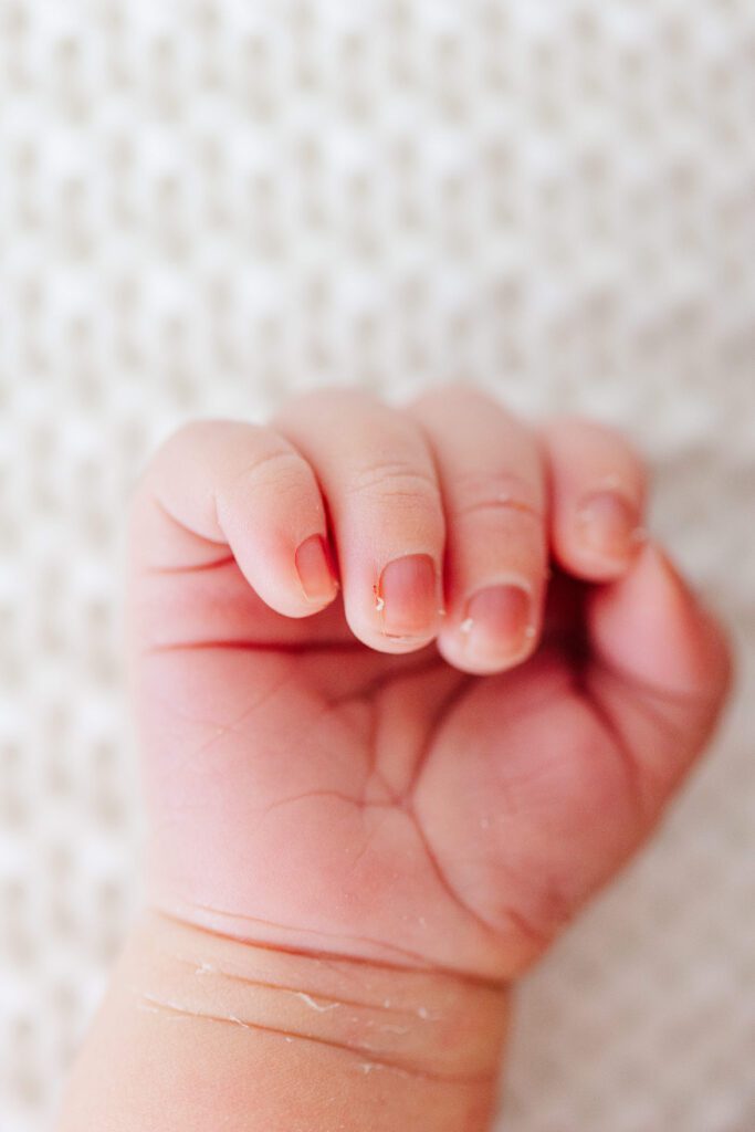 Newborn close up on her hand.