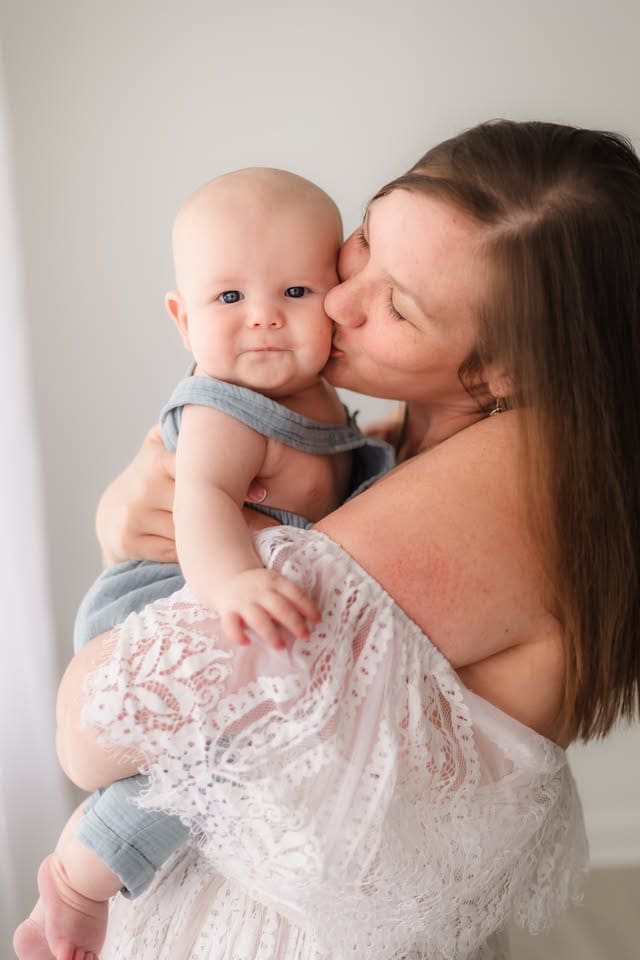 mom kissing baby's cheek